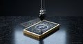 Tarot Cards with a crystal hung over them sitting on top of a black marble countertop. 